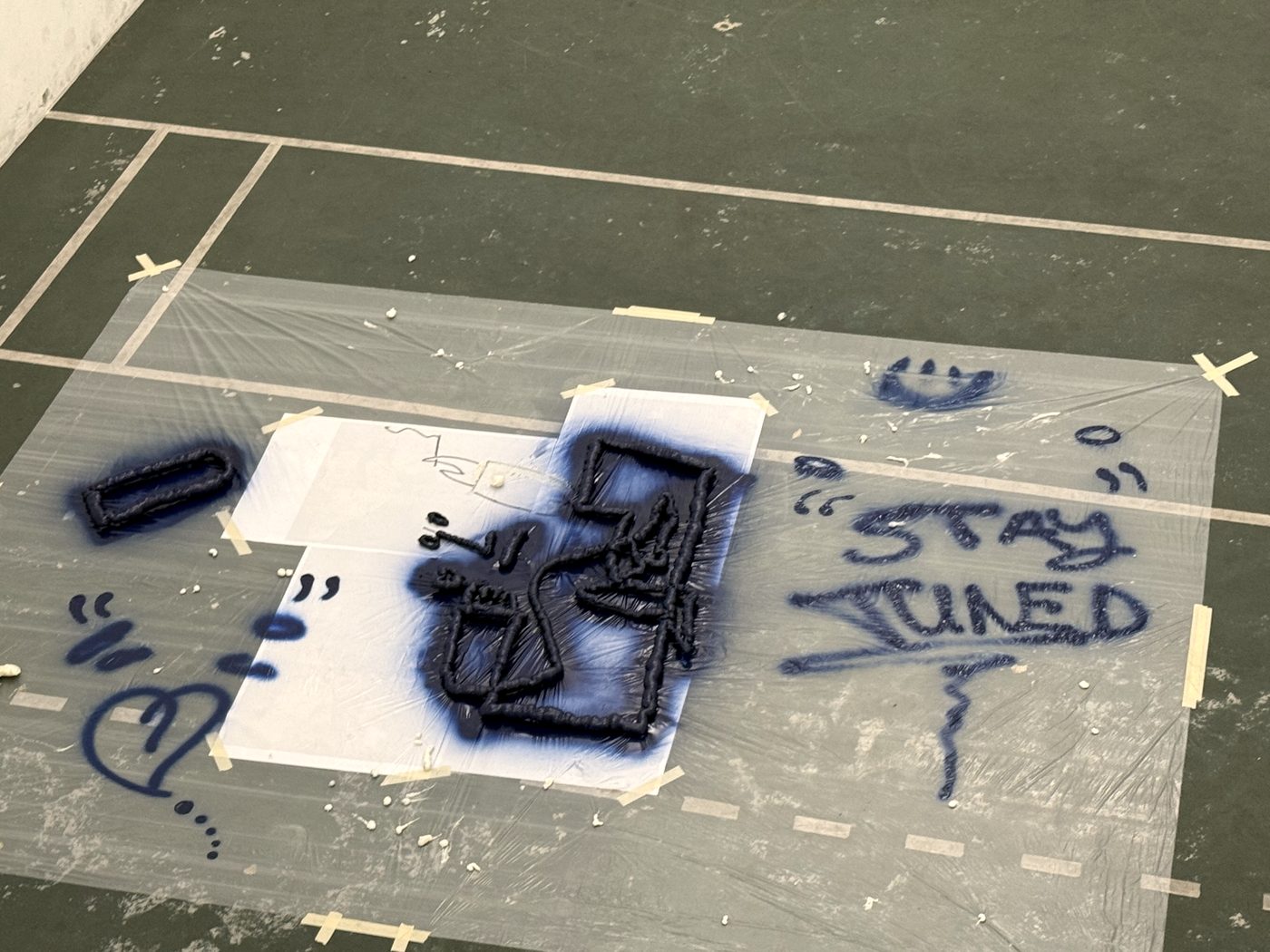 Spray-painted stencil on the studio floor